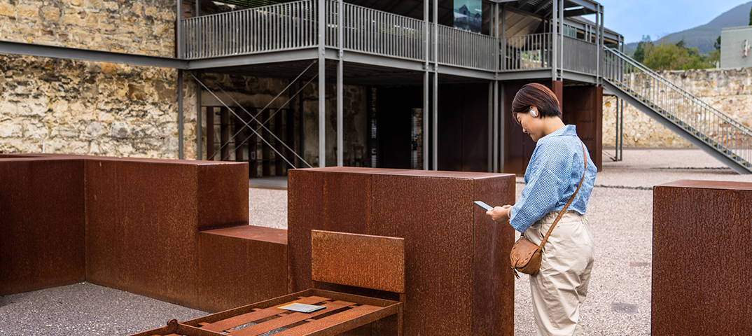 Woman using audio tour | Cascades Female Factory | Historic Site Australia
